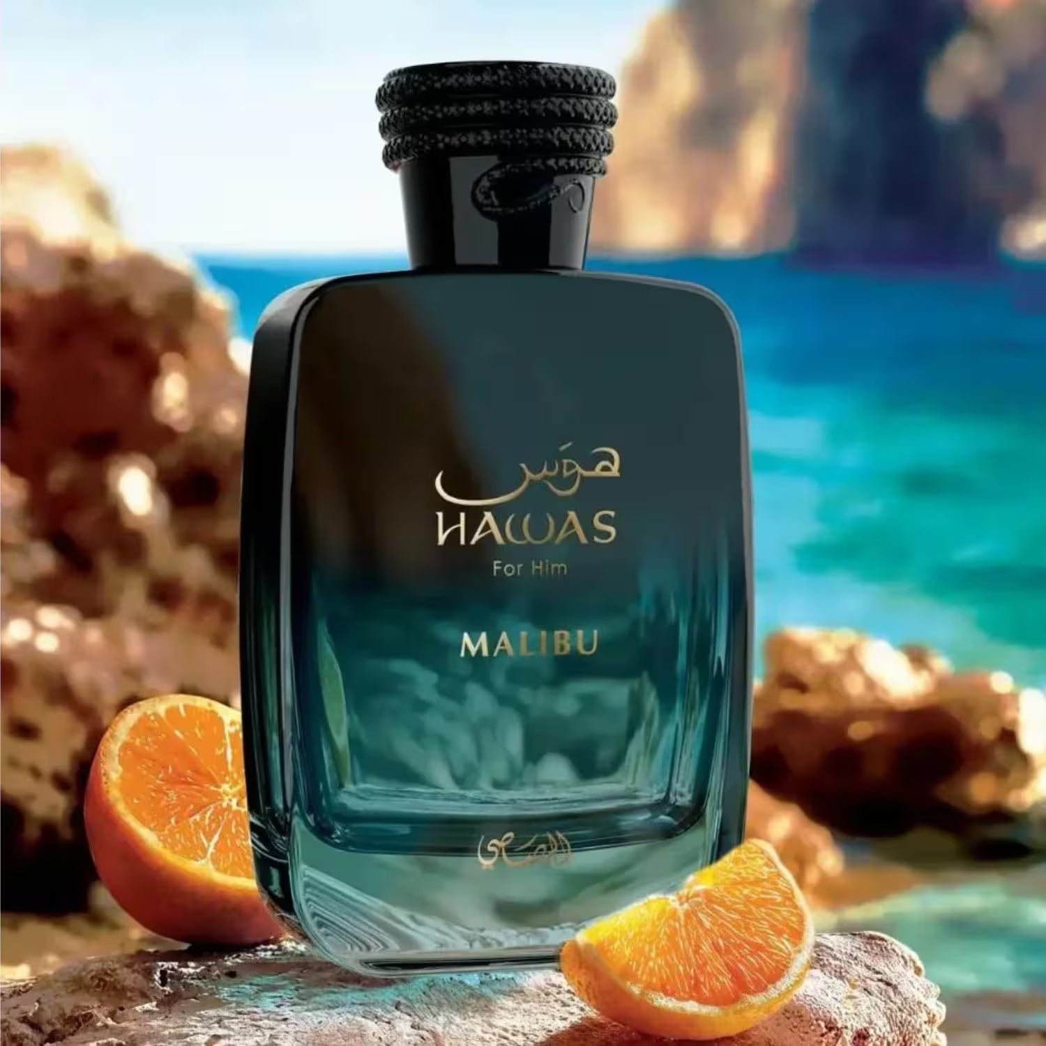Malibu Hawas perfume bottle with orange slices on a beach background