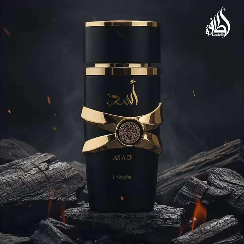 Black and gold perfume bottle labeled 'Asad' on a dark background with fire and coals.
