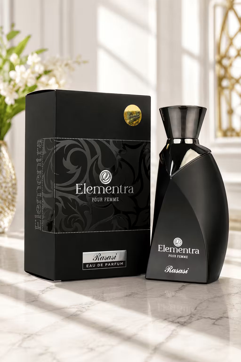 Elementra Pour Femme Kansi Eau de Parfum bottle and its black packaging box, displayed on a marble surface with soft window light.