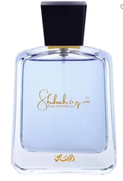 A bottle of Shubhair Pour Homme fragrance with a clear glass body showing light blue liquid, a black cap, and gold lettering on a white background.