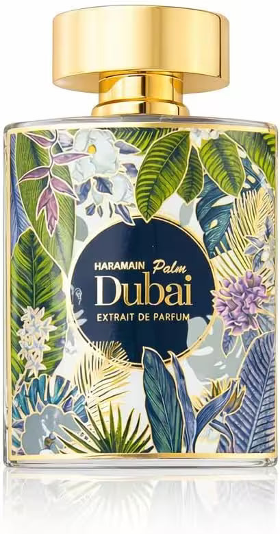 A rectangular glass perfume bottle for Haramain Palm Dubai Extrait de Parfum, featuring a gold cap and a tropical floral pattern with green leaves, blue and purple flowers, and a dark blue central label.