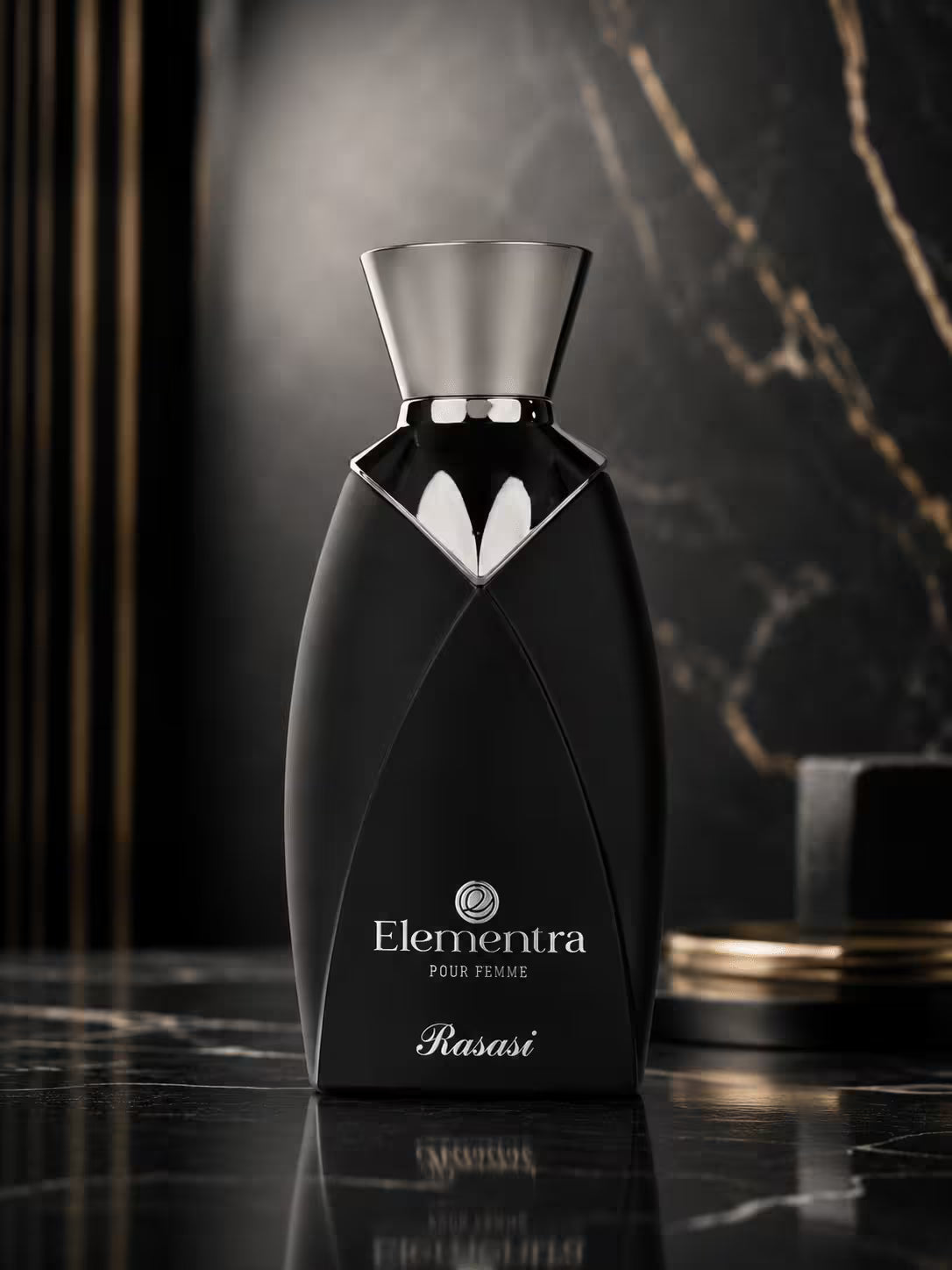 Elementra Pour Fouir Rasasi perfume bottle in black with a silver metallic cap, set on a dark marble surface with a dark marble background.