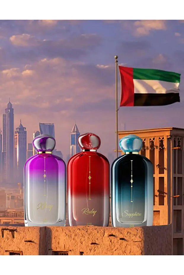 Three perfume bottles with a cityscape and flag in the background